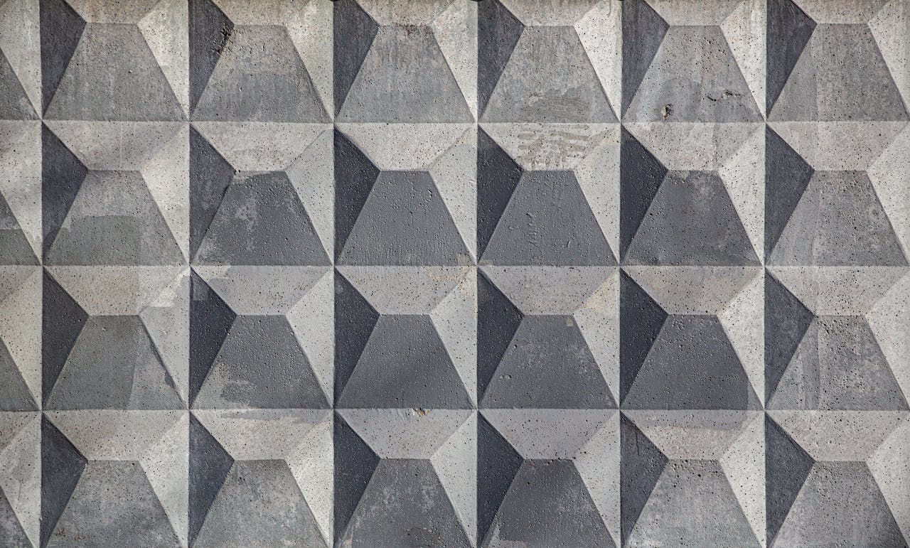 hero-img-01 Close-up of a textured geometric concrete wall with a pattern.